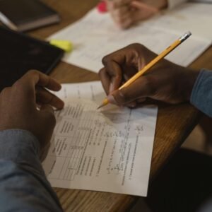 Person Writing on White Paper