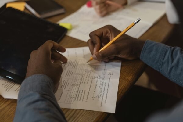 Person Writing on White Paper